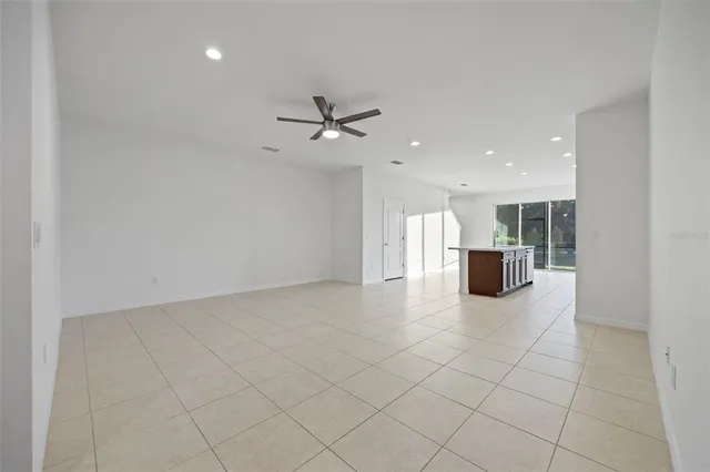 an empty room with a ceiling fan and a ceiling fan
