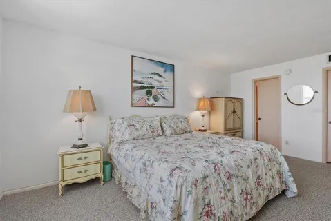 a bedroom with a bed and a lamp on table