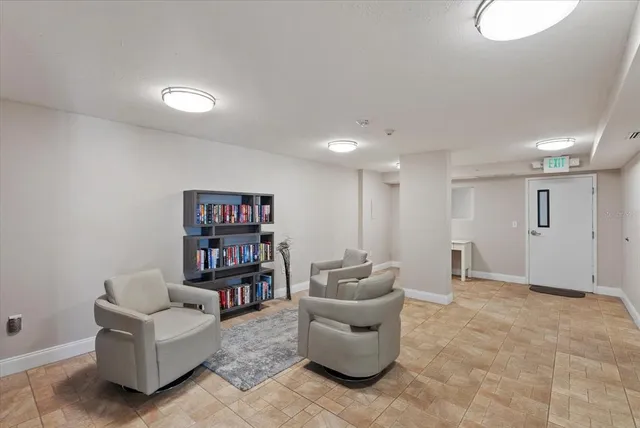 a living room with furniture and a book shelf