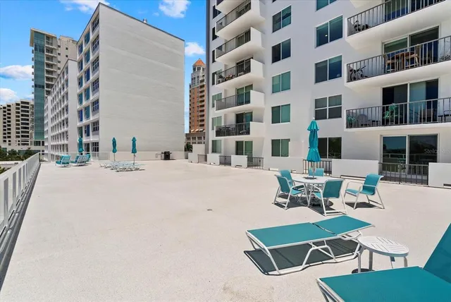 a view of a patio with a table and chairs