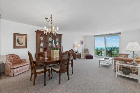 a dining room with furniture a chandelier and a rug