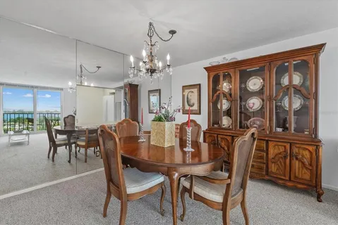 a view of a dining room with furniture and a chandelier