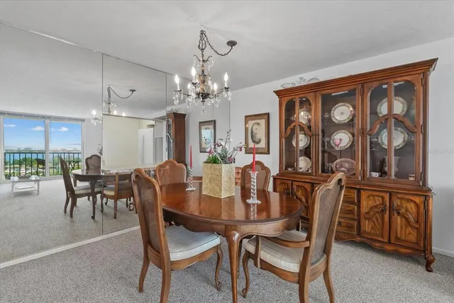 a view of a dining room with furniture and a chandelier