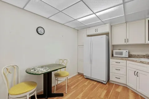a kitchen with stainless steel appliances a stove a refrigerator and white cabinets