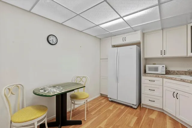 a kitchen with stainless steel appliances a stove a refrigerator and white cabinets