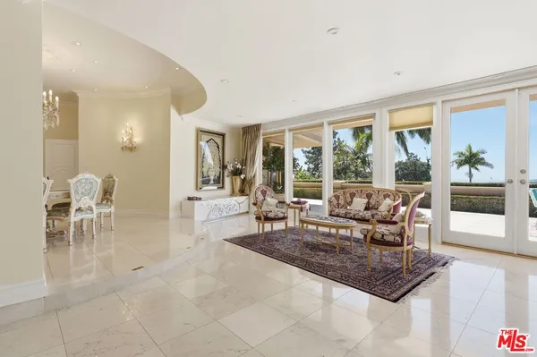 a living room with furniture and large windows