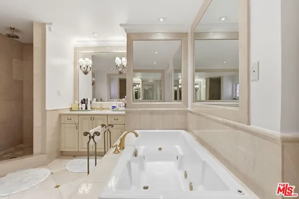 a bathroom with a granite countertop shower a sink and a mirror