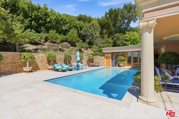 a view of house with outdoor space and swimming pool