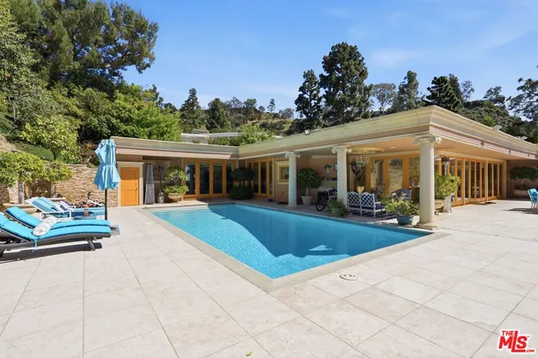 a view of swimming pool with outdoor seating and plants