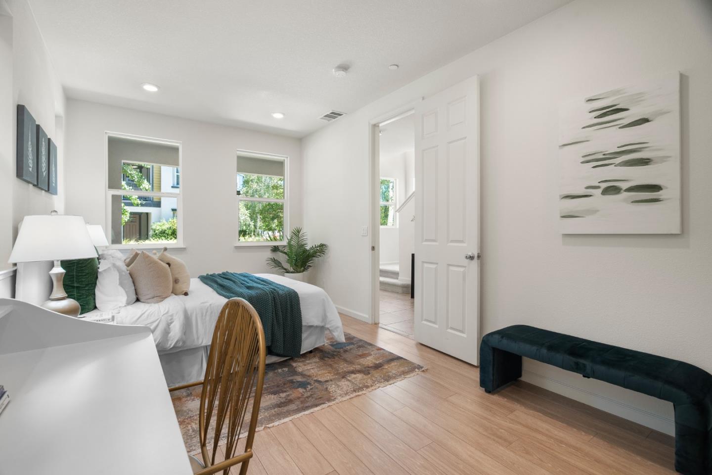 1789 Infinity Way San Jose, CA 95122 - Photo 19 of 44 a spacious bedroom with a bed a couch and a potted plant with wooden floor
