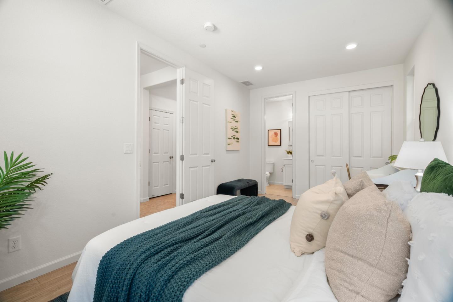 1789 Infinity Way San Jose, CA 95122 - Photo 20 of 44 a bedroom with a large bed and a potted plant
