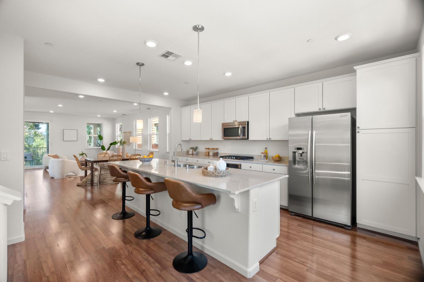 1789 Infinity Way San Jose, CA 95122 - Photo 3 of 44 a kitchen with stainless steel appliances a stove a sink a refrigerator and white cabinets with wooden floor