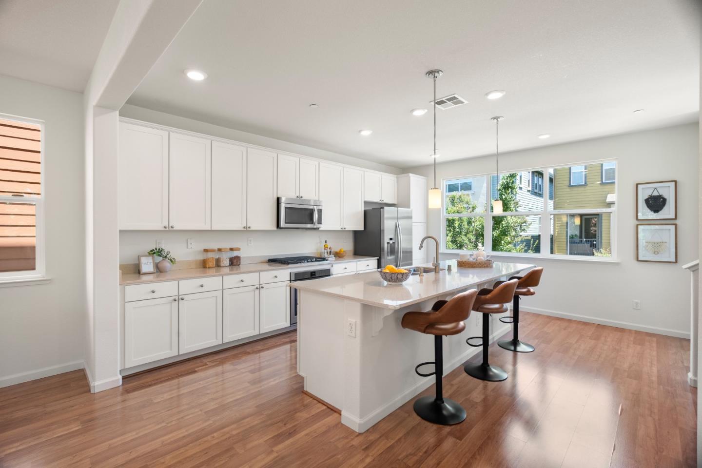 1789 Infinity Way San Jose, CA 95122 - Photo 5 of 44 a kitchen with stainless steel appliances a stove a sink a refrigerator and white cabinets with wooden floor