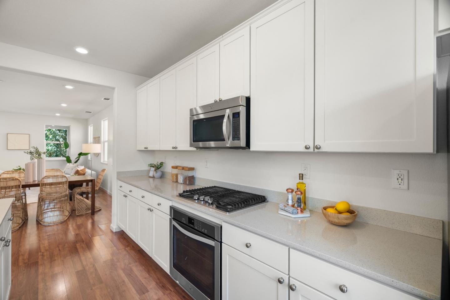 1789 Infinity Way San Jose, CA 95122 - Photo 6 of 44 a kitchen with stainless steel appliances white cabinets sink and wooden floor