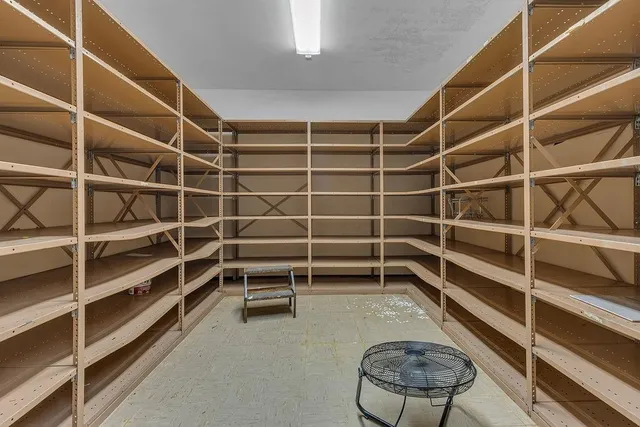 a view of an empty room with empty shelves