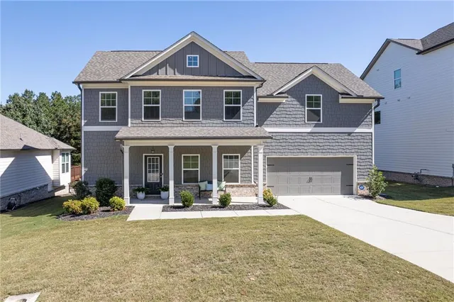 a front view of a house with a yard