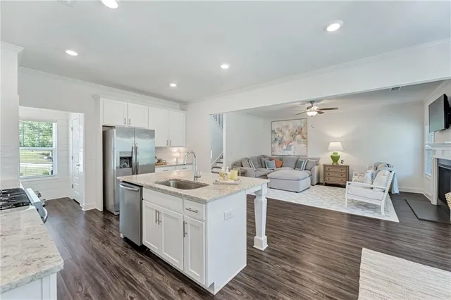 a kitchen with a sink stove and refrigerator