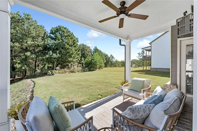 a view of a swimming pool and deck with furniture