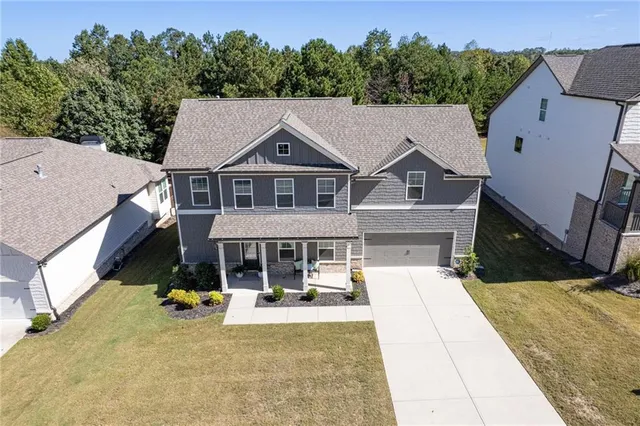 an aerial view of a house with table and chairs