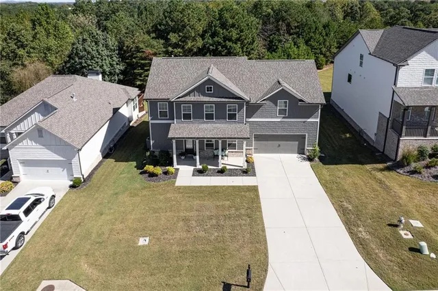 an aerial view of residential houses with outdoor space