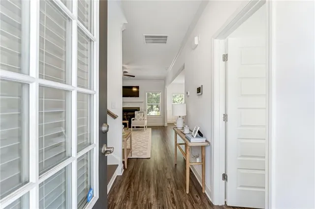 a view of a living room with furniture and wooden floor
