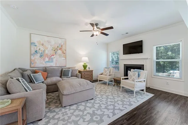 a living room with furniture a fireplace and a flat screen tv