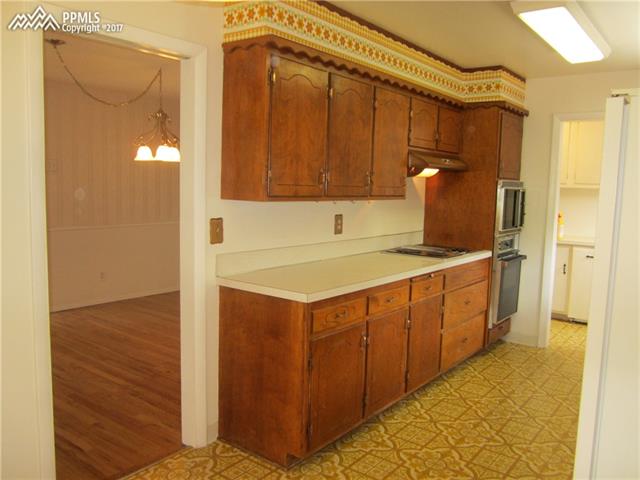823 Cresta Road Colorado Springs, CO 80905 - Photo 36 of 36 Eat-in Kitchen is open on both sides featuring an open flow floor plan with direct access to the dining room and Laundry/Mud Room area. Kitchen can be easily closed of by original pocket door.