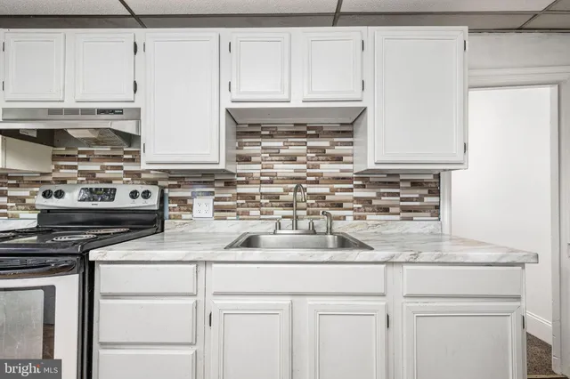 a kitchen with appliances cabinets and a counter top space