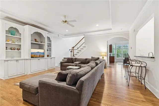 a living room with furniture and a wooden floor