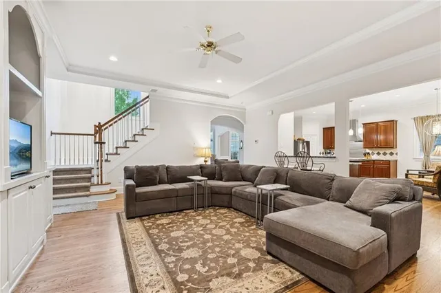 a living room with furniture ceiling fan and a rug