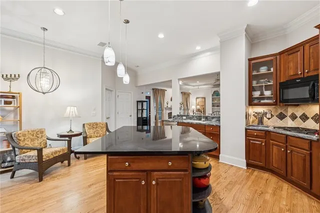a kitchen with stainless steel appliances granite countertop a stove and cabinets