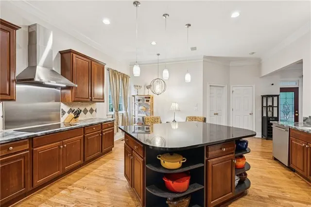 a kitchen with granite countertop a sink a stove and cabinets