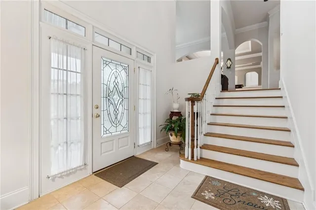 a view of entryway with stairs and front door