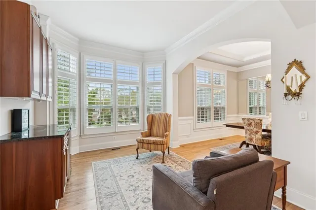 a living room with furniture and large windows