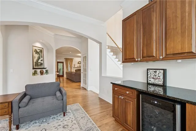 a living room with granite countertop furniture a rug a flat screen tv and a window