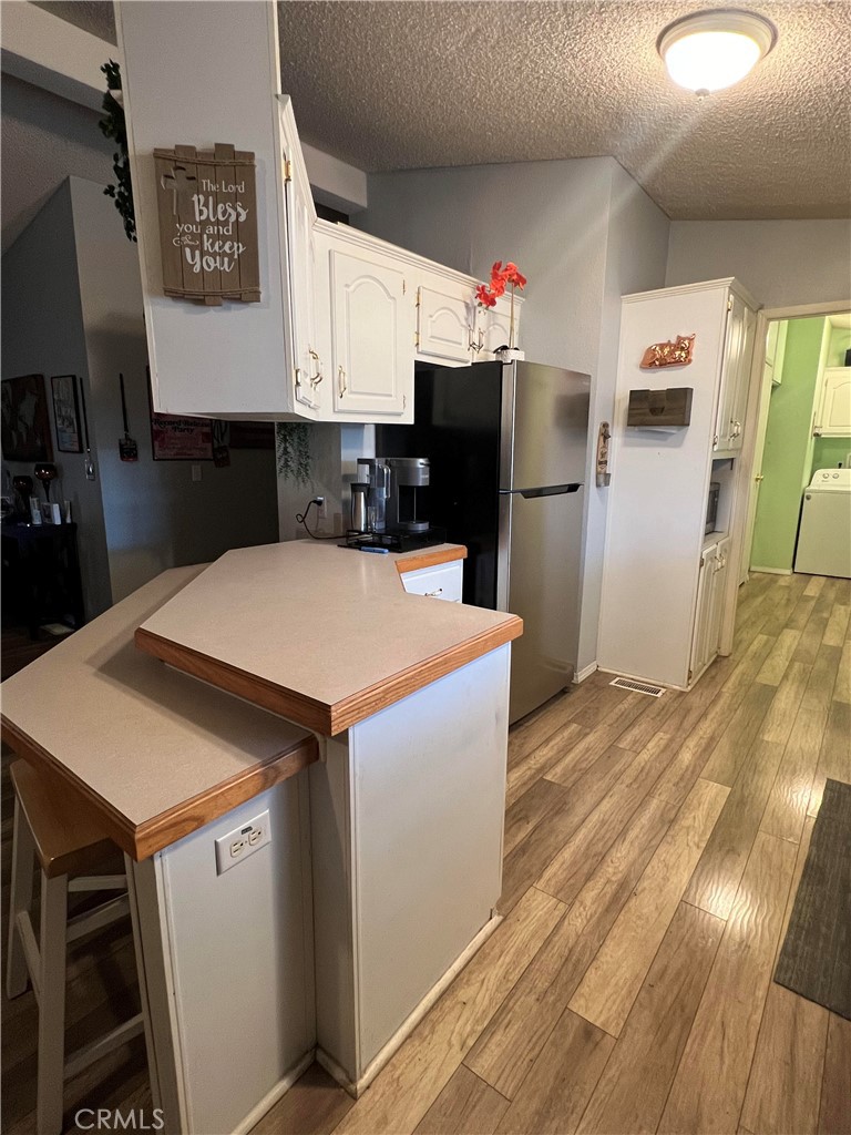 2020 Ashby Road, Unit 22 Merced, CA 95348 - Photo 11 of 25 a kitchen that has a refrigerator and a stove