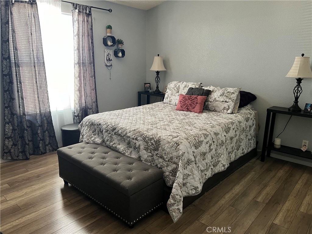 2020 Ashby Road, Unit 22 Merced, CA 95348 - Photo 22 of 25 a bedroom with a bed couch and a window