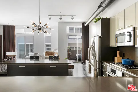 a kitchen with stainless steel appliances a sink a stove and a refrigerator