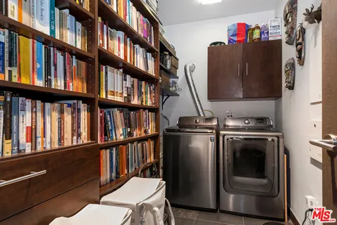 a view of a kitchen with furniture and a book shelf