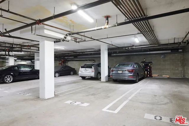 a view of parking garage with cars