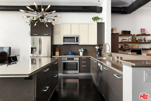 a kitchen with stainless steel appliances a sink a stove and a refrigerator