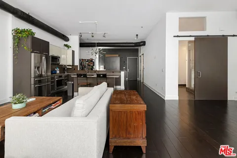 a kitchen with stainless steel appliances kitchen island granite countertop a refrigerator and a stove top oven