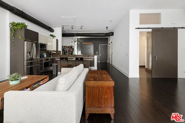 a kitchen with stainless steel appliances kitchen island granite countertop a refrigerator and a stove top oven