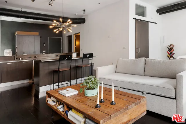 a living room with furniture and a chandelier
