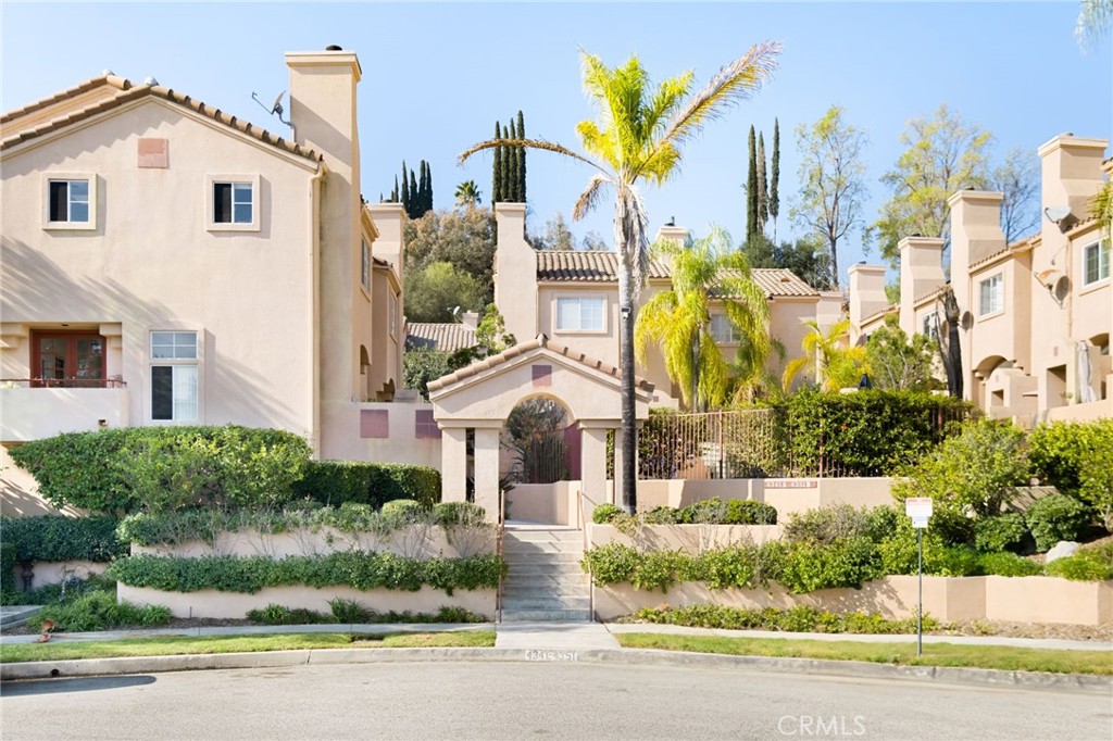4347 Freedom Drive, Unit B Calabasas, CA 91302 - Photo 1 of 1 a front view of a house with a garden and plants