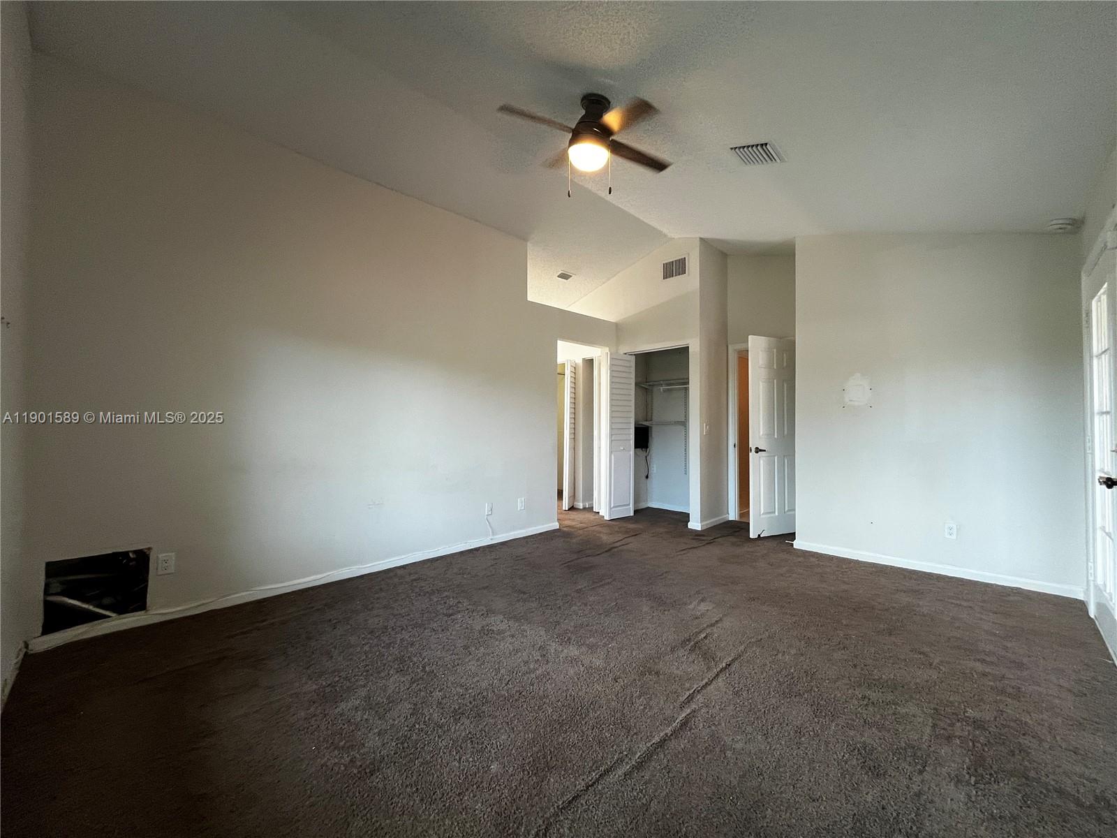 8079 Popash Court Boynton Beach, FL 33472 - Photo 11 of 30 a view of an empty room with a ceiling fan