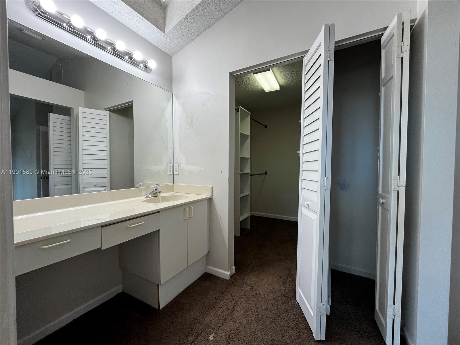 8079 Popash Court Boynton Beach, FL 33472 - Photo 12 of 30 a bathroom with a double vanity sink and a mirror