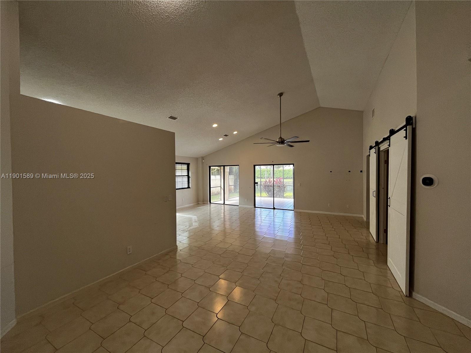 8079 Popash Court Boynton Beach, FL 33472 - Photo 20 of 30 a view of a hallway with a chandelier