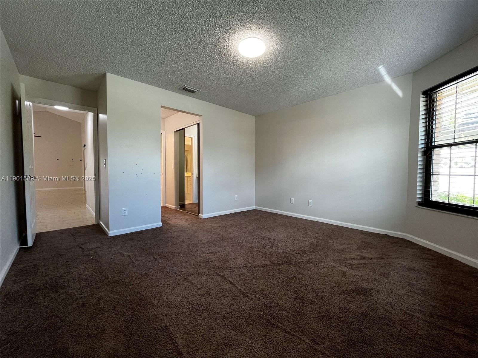 8079 Popash Court Boynton Beach, FL 33472 - Photo 22 of 30 an empty room with windows and closet