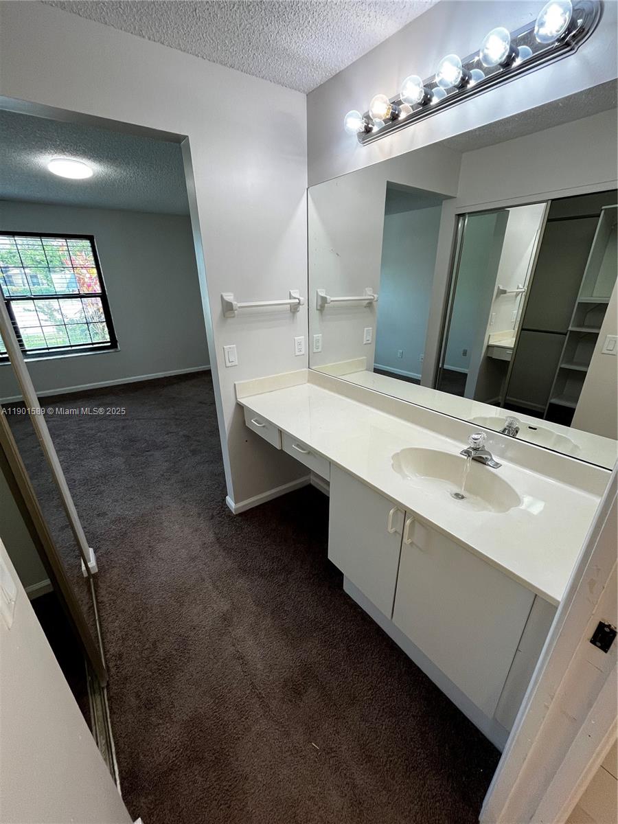 8079 Popash Court Boynton Beach, FL 33472 - Photo 24 of 30 a bathroom with a double vanity sink a and mirror